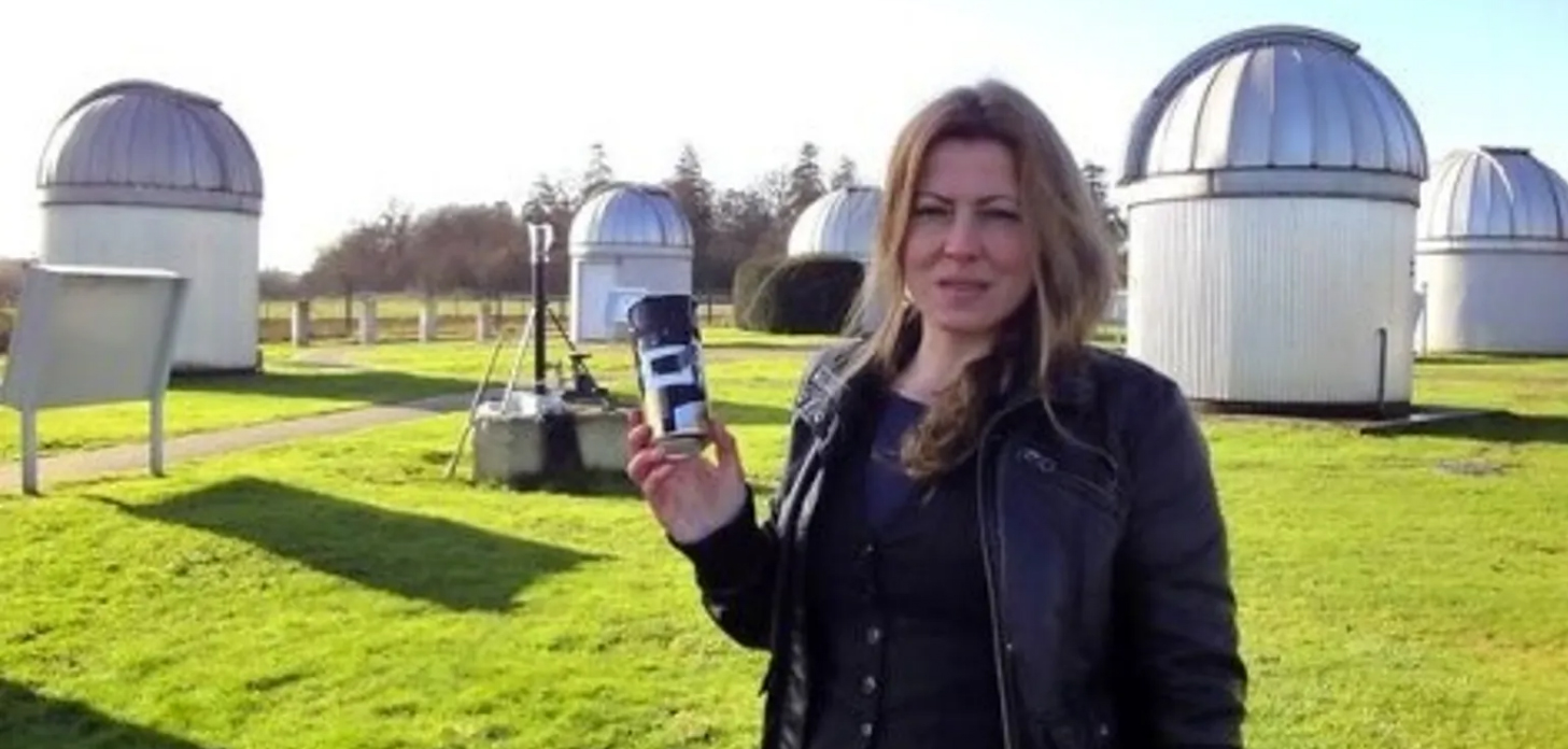 Regina Valkenborgh with her cider can camera in front of the observatory domes
